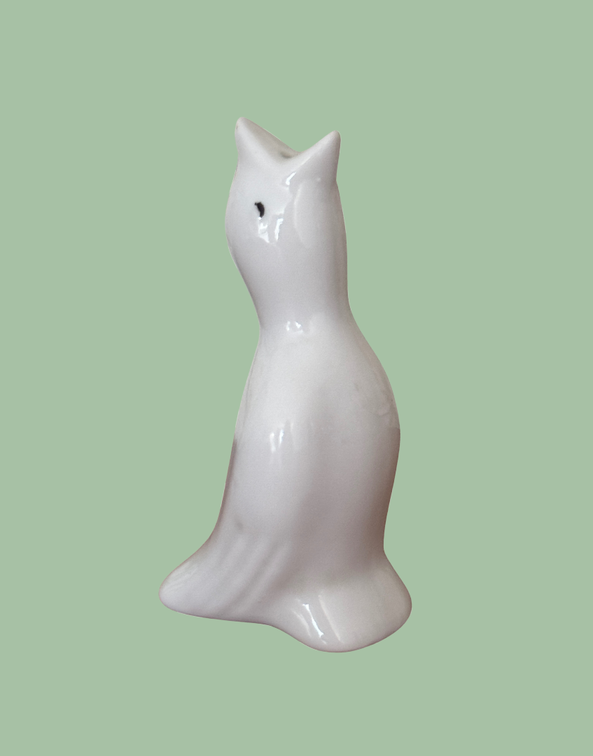 Side view of classic white ceramic pie bird with black eye and wing detail.
