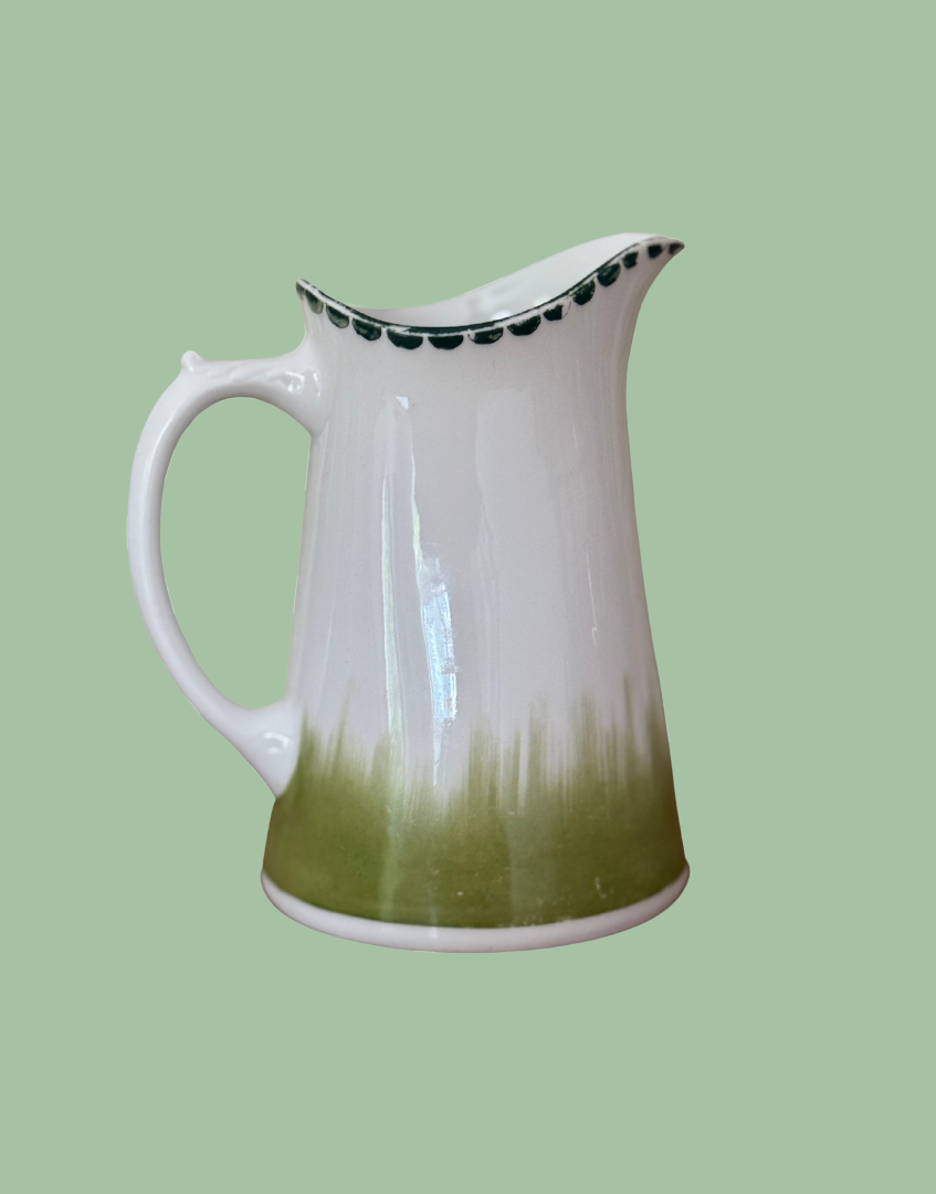 White antique ceramic pitcher with green grass illustration