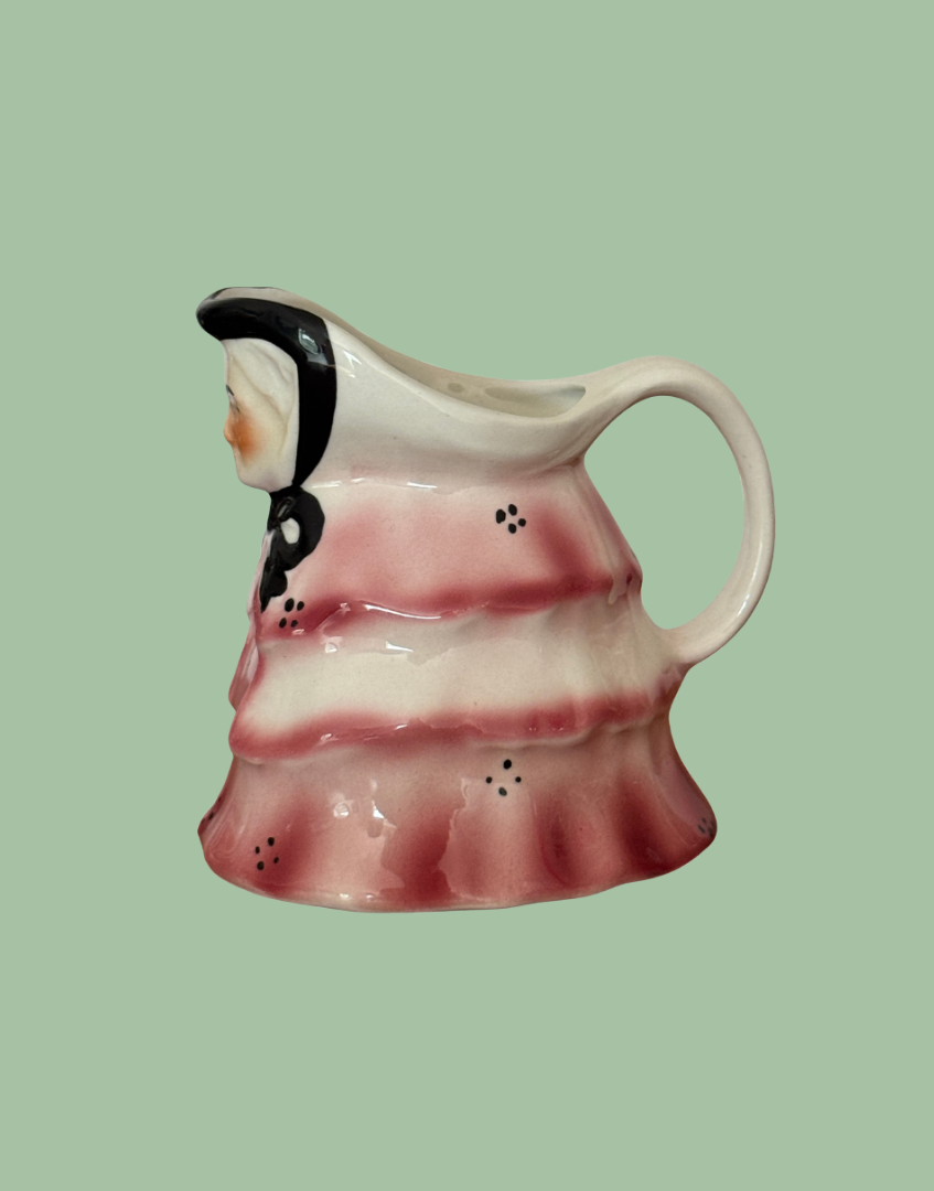 Side view of small ceramic milk creamer of old lady