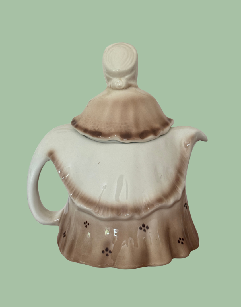 Reverse side of Tony Wood Little Old Lady teapot showing brown glazed dress and rear bonnet detail