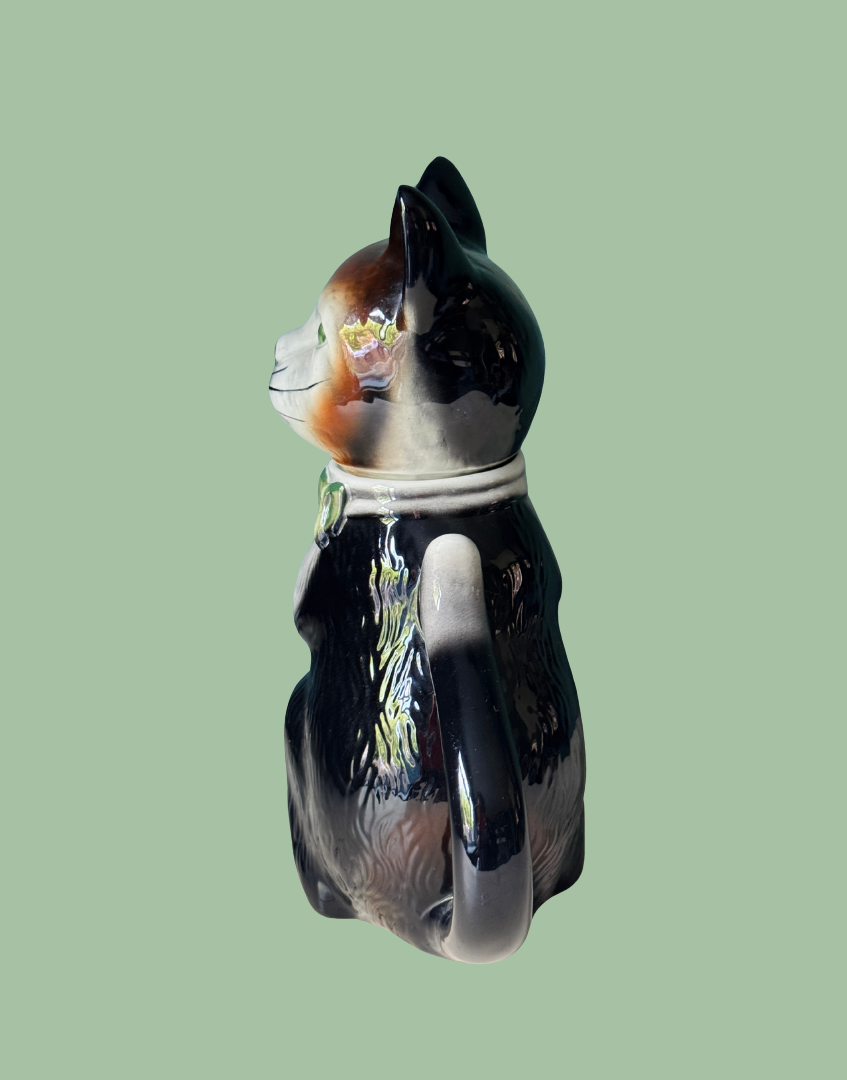 Side view of Tony Wood cat shaped pottery teapot showing tail handle