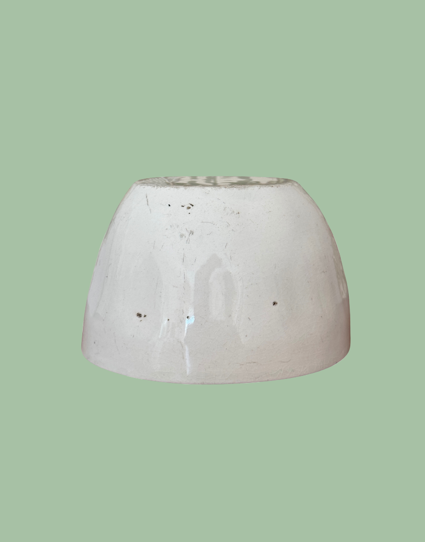 Back view of white antique ceramic blancmange mould