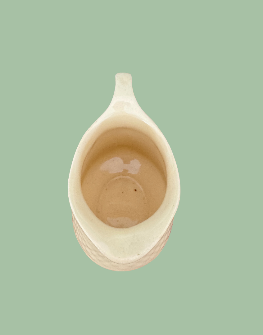 Over view of pastel yellow vintage ceramic milk creamer