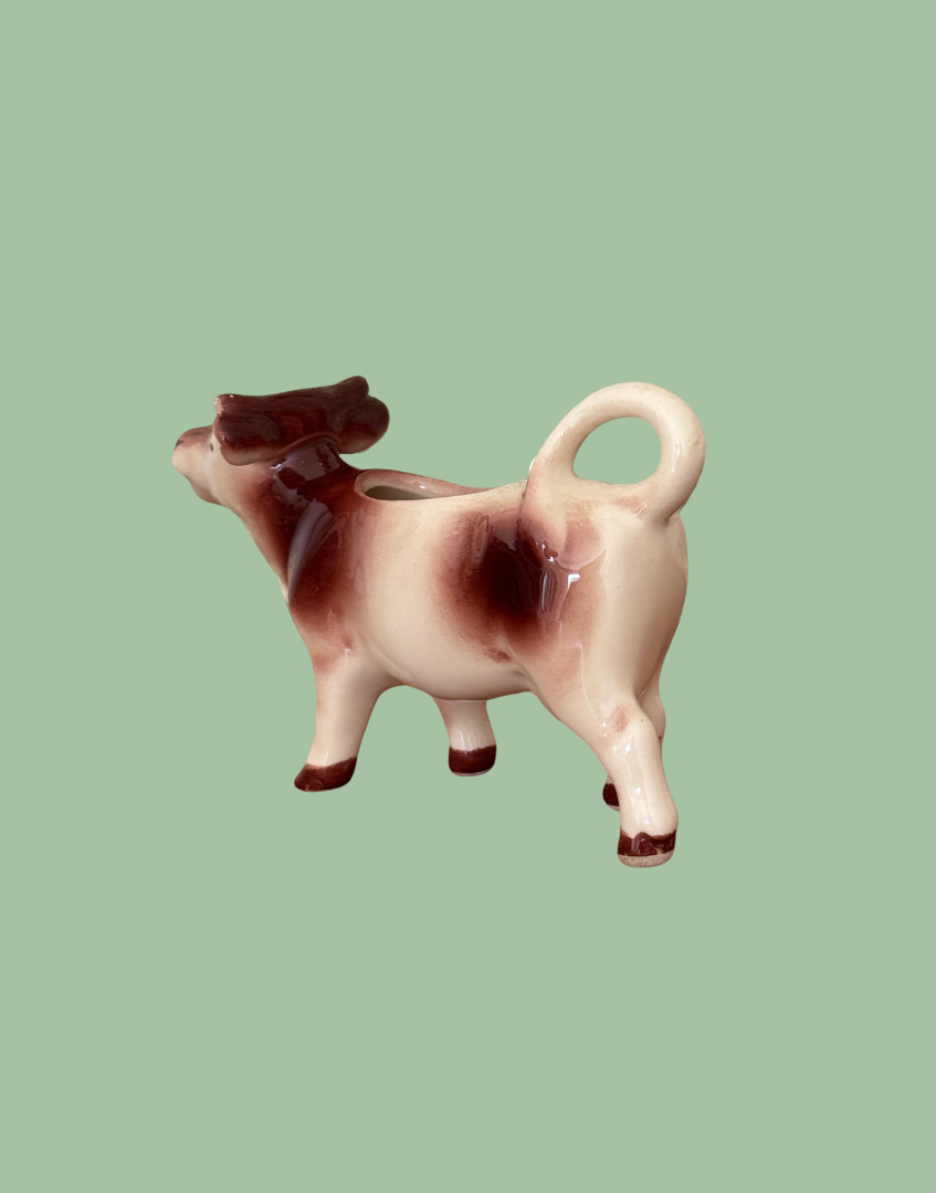 Rear view of ceramic mid century bron and cream cow creamer collectable