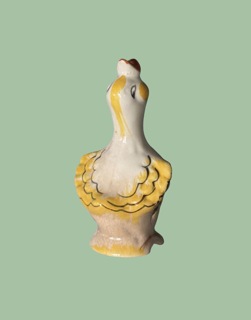 Back view of vintage kissy lips collectable pie bird baking tool with pretty feather detail