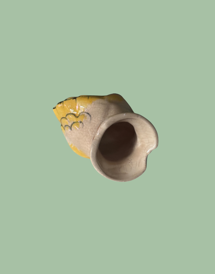 Underside of peach and yellow collectable pie bird kitchenware