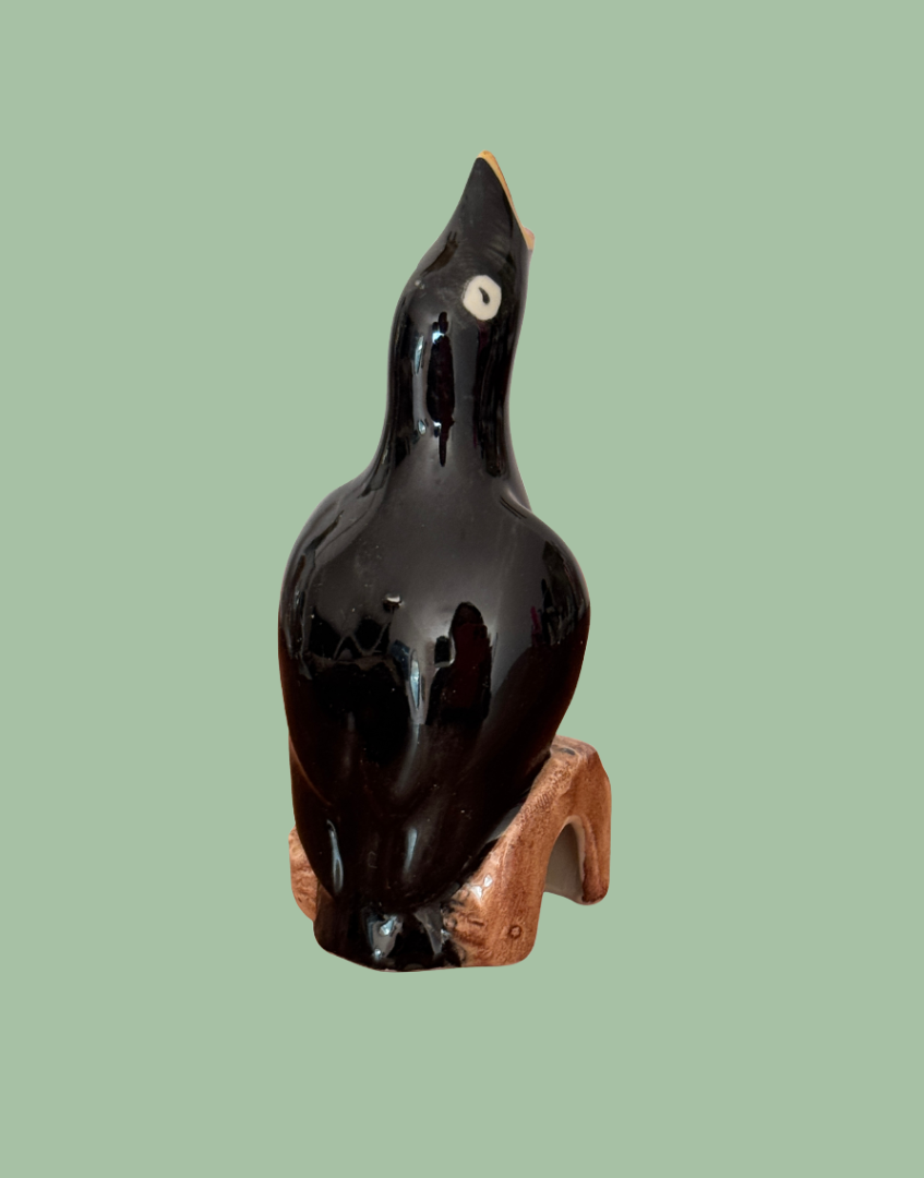 Back view of ceramic bak bird on log kitchenware