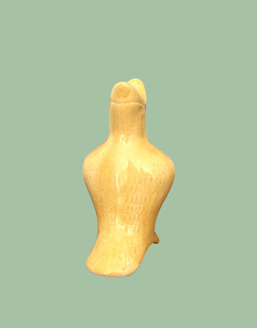Back view of primrose yellow glossy ceramic pie bird with fine feather detail