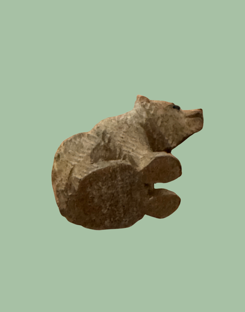 Small Black Forest bear carving base view showing underside detail