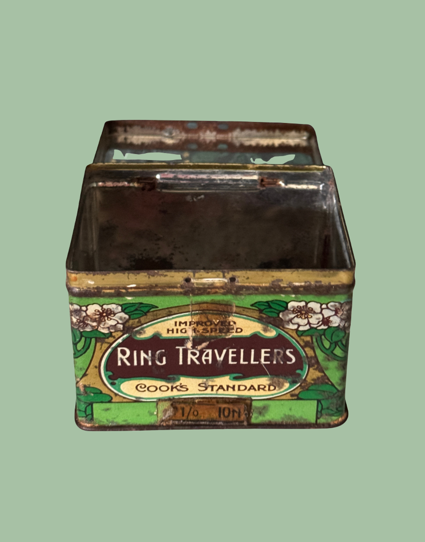 Vintage art nouveau tin with 'Ring Travellers' branding with lid open