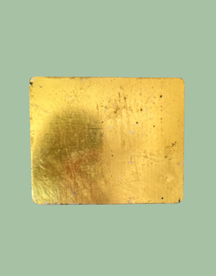 Gold tone base of antique tobacco tin