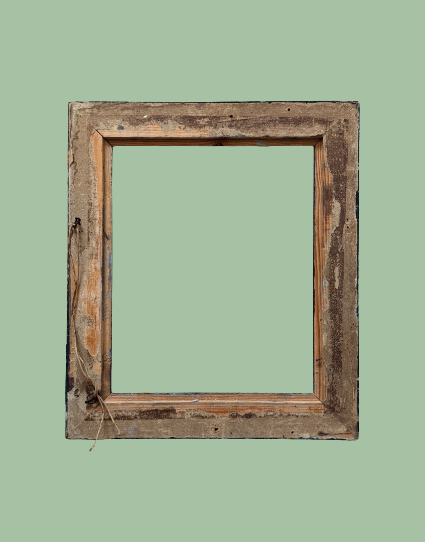A rustic, weathered wooden picture frame with a distressed finish, shown against a solid sage green background.