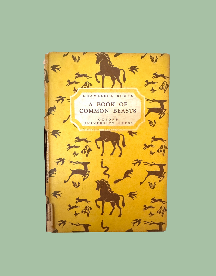 Vintage hardcover book titled 'A Book of Common Beasts' by Charles Darwin, published by Cambridge University Press under Chameleon Books. The cover is a warm mustard yellow with dark brown silhouettes of animals and a central cream label.