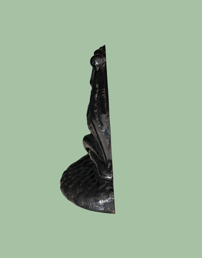 Side profile of vintage black cast iron frog doorstop with detailed features