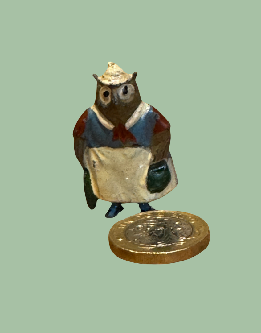 Collectable miniature Britains owl collectable lead toy next to one pound coin