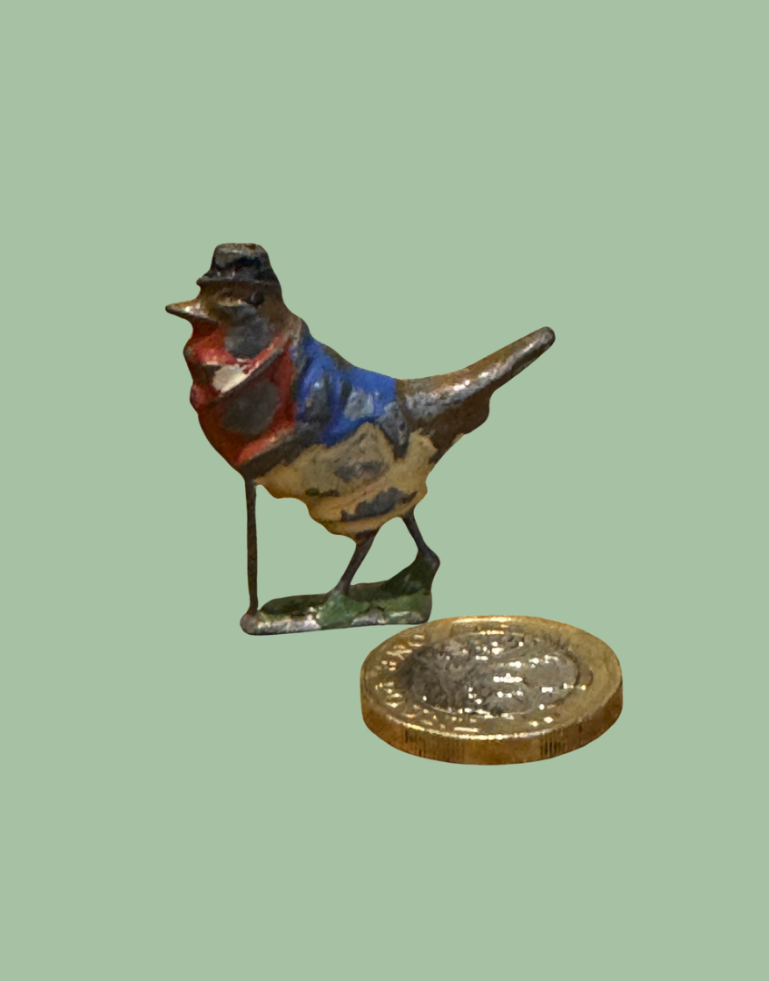 ‘Gussie Robin’ Britains Antique Lead Figurine next to One Pound Coin