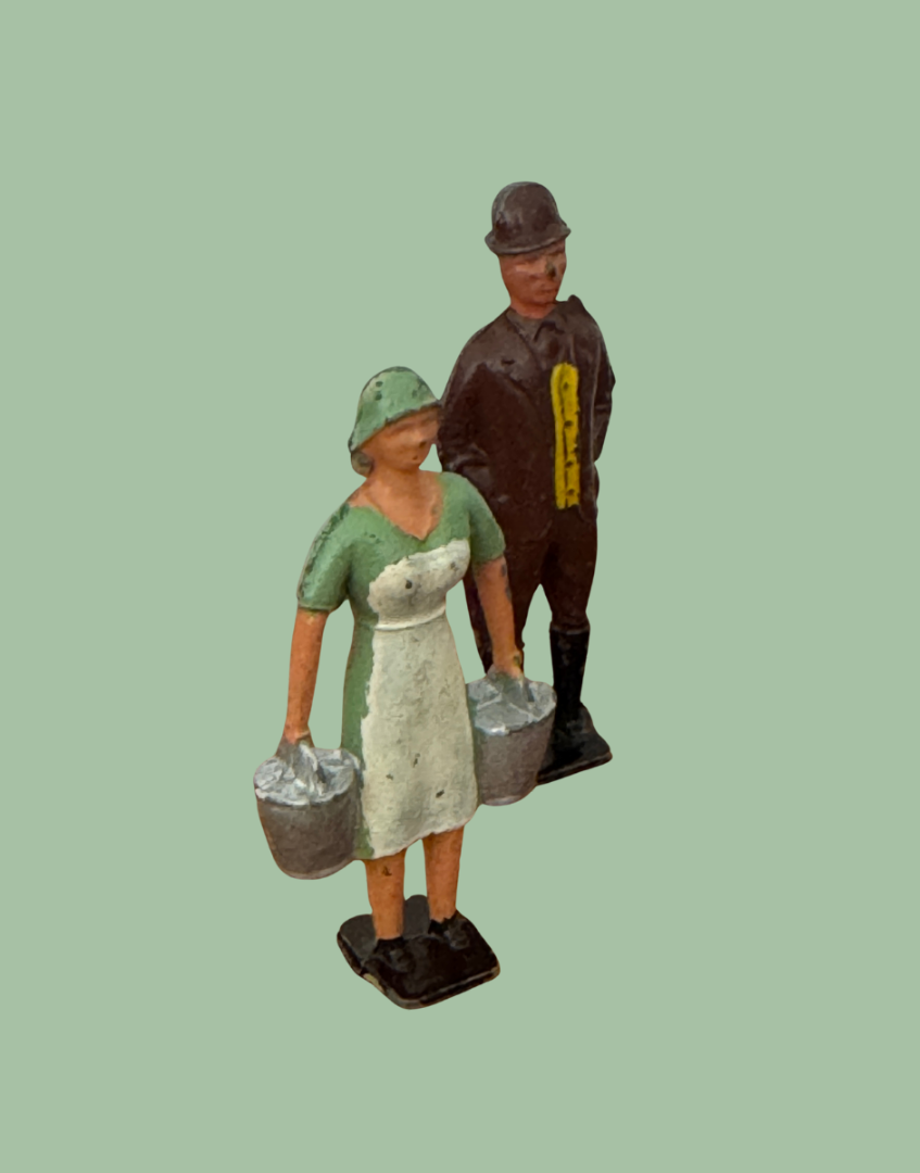 side view of a milk maid lead figurine and a country gentleman