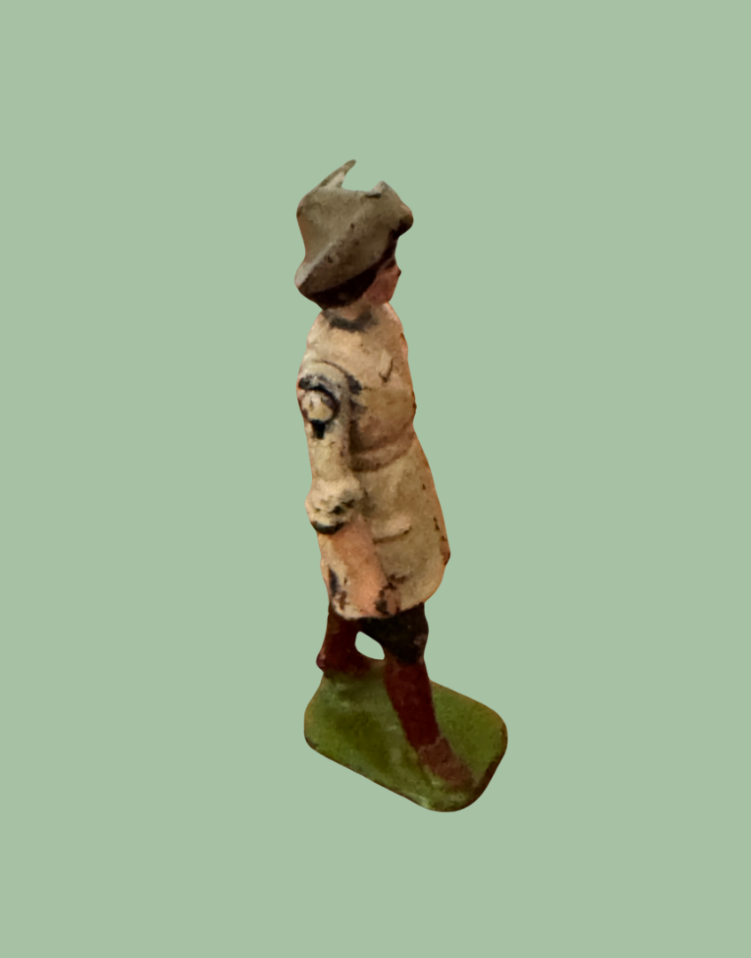 Side view of Britains Land Girl vintage lead figure showing traditional working clothing and articulated arm