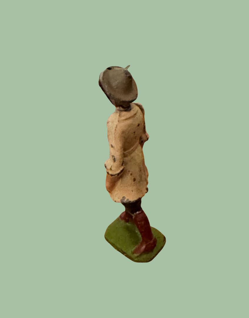 Side view of Britains 1920s Land Girl figure showing green painted base and hand-painted detailing