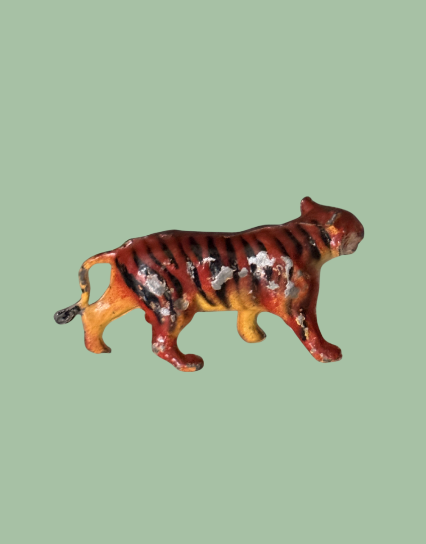 Decorative britains lead tiger figurine on a polka dot background