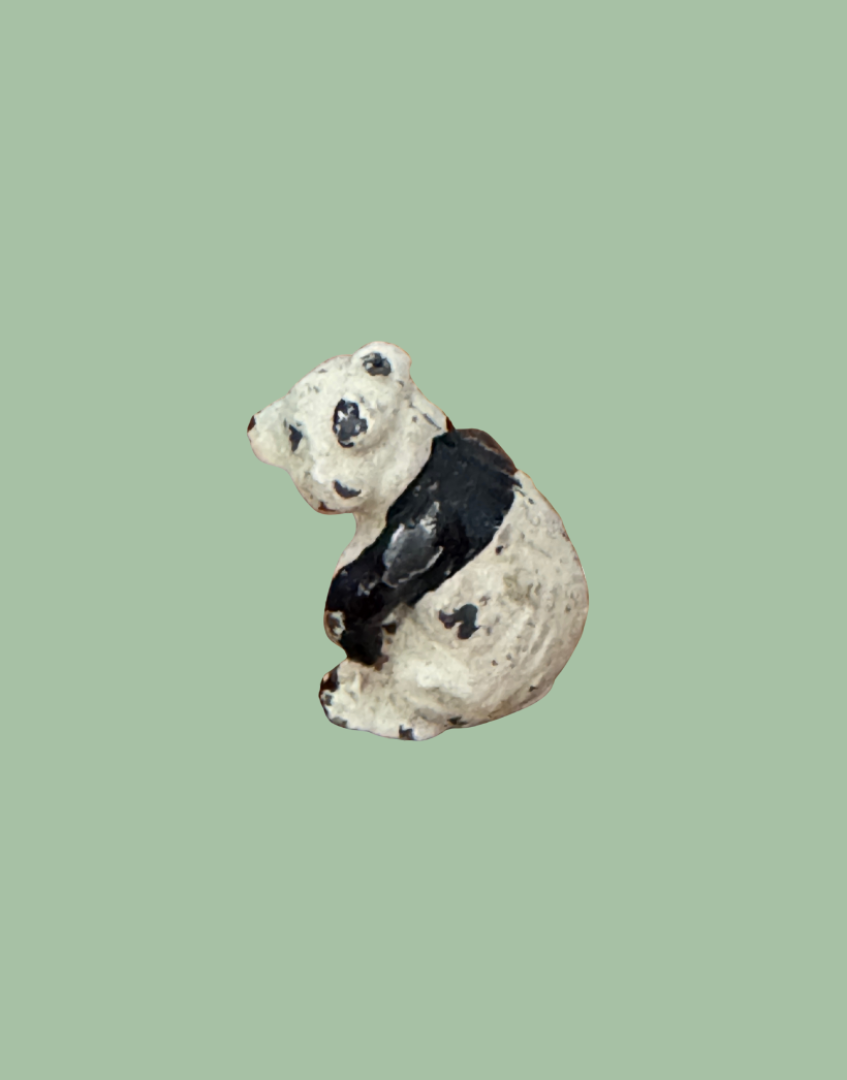 rear side view of tiny sweet black and white panda toy