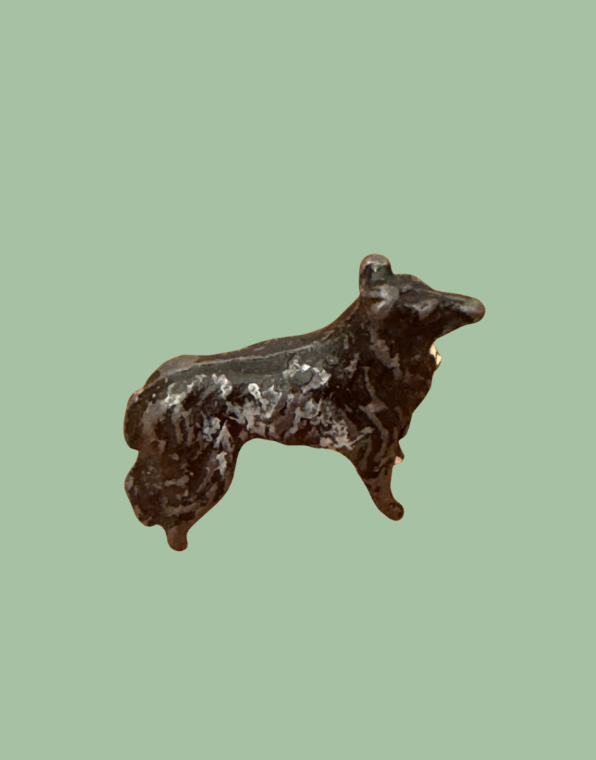side view showing agewear and patina on britains miniature farm dog