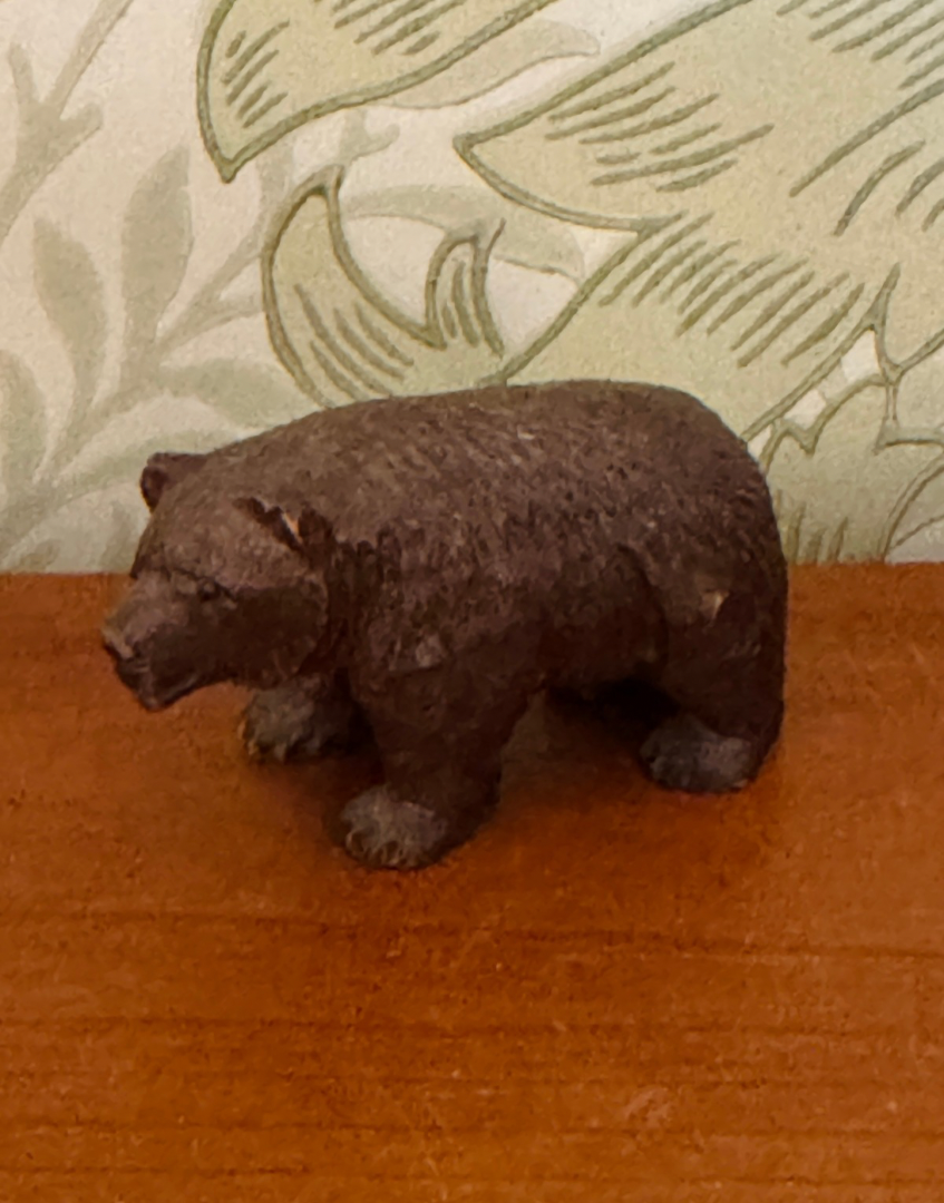 A small carved brown bear figurine