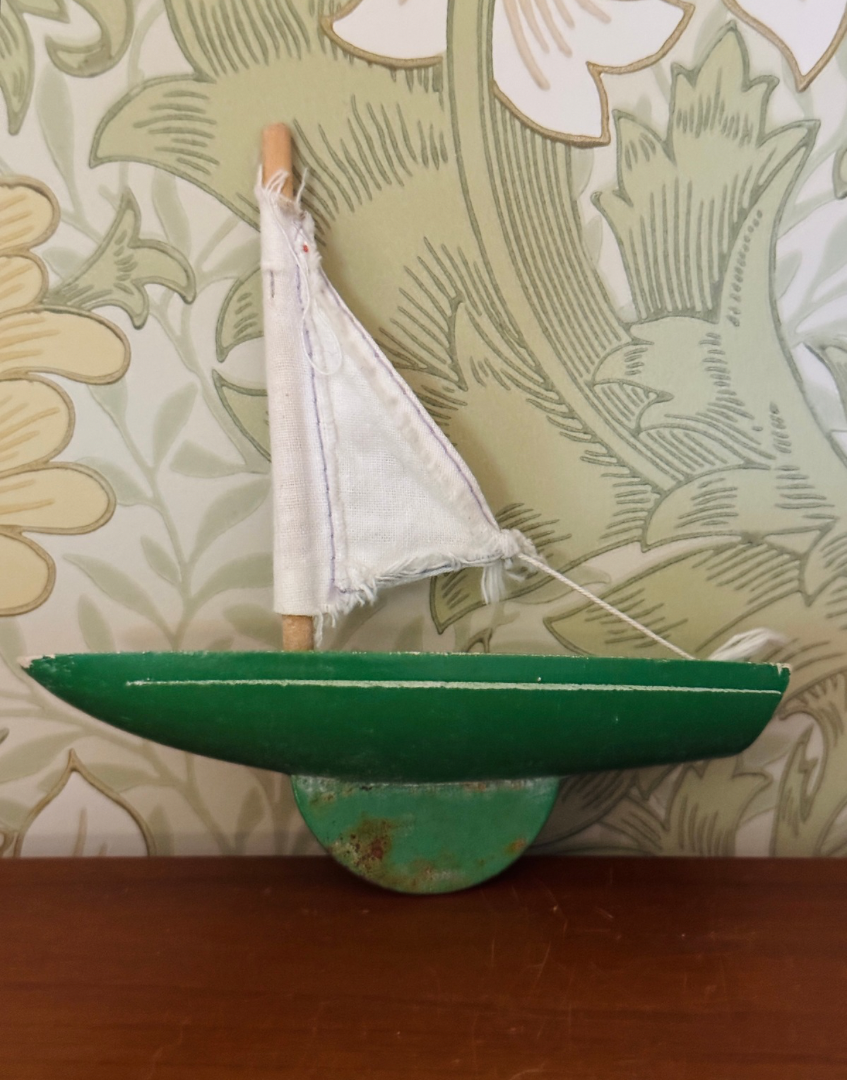Vintage green Star Yachts pond yacht styled on a wooden shelf