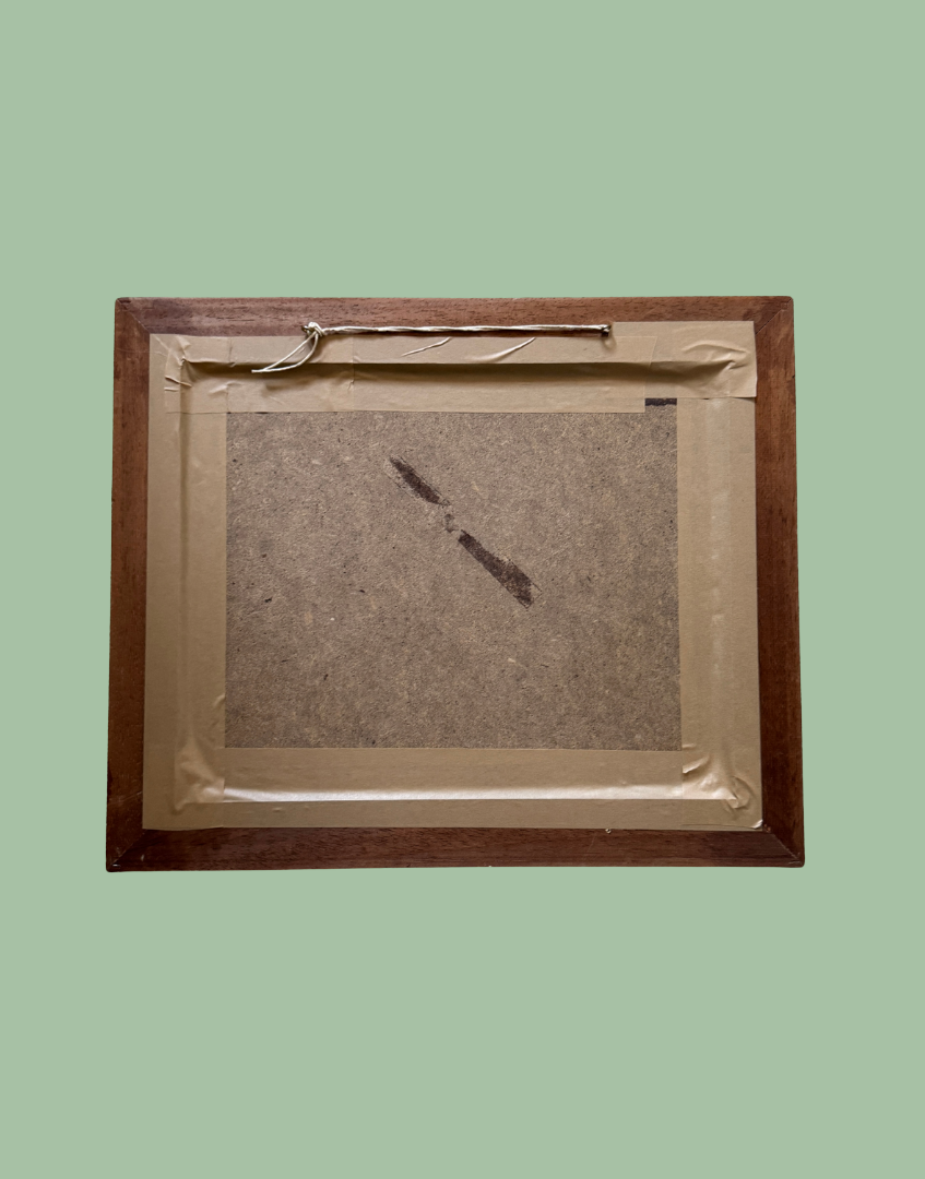 The back of a square wooden picture frame with a metal hanging bar, showing a brown cardboard insert secured with tape, set against a solid sage green background.