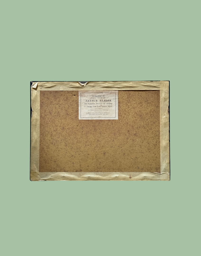 The back view of a framed art print or canvas, showing a textured brown backing board, a gold foil border, and a white paper label at the top center, set against a solid sage green background.