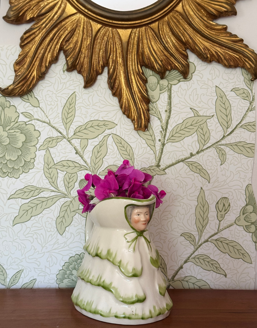Rare green Tony Wood Little Old Lady jug with sweet pea flowers styled on wooden shelf with vintage cottage decor