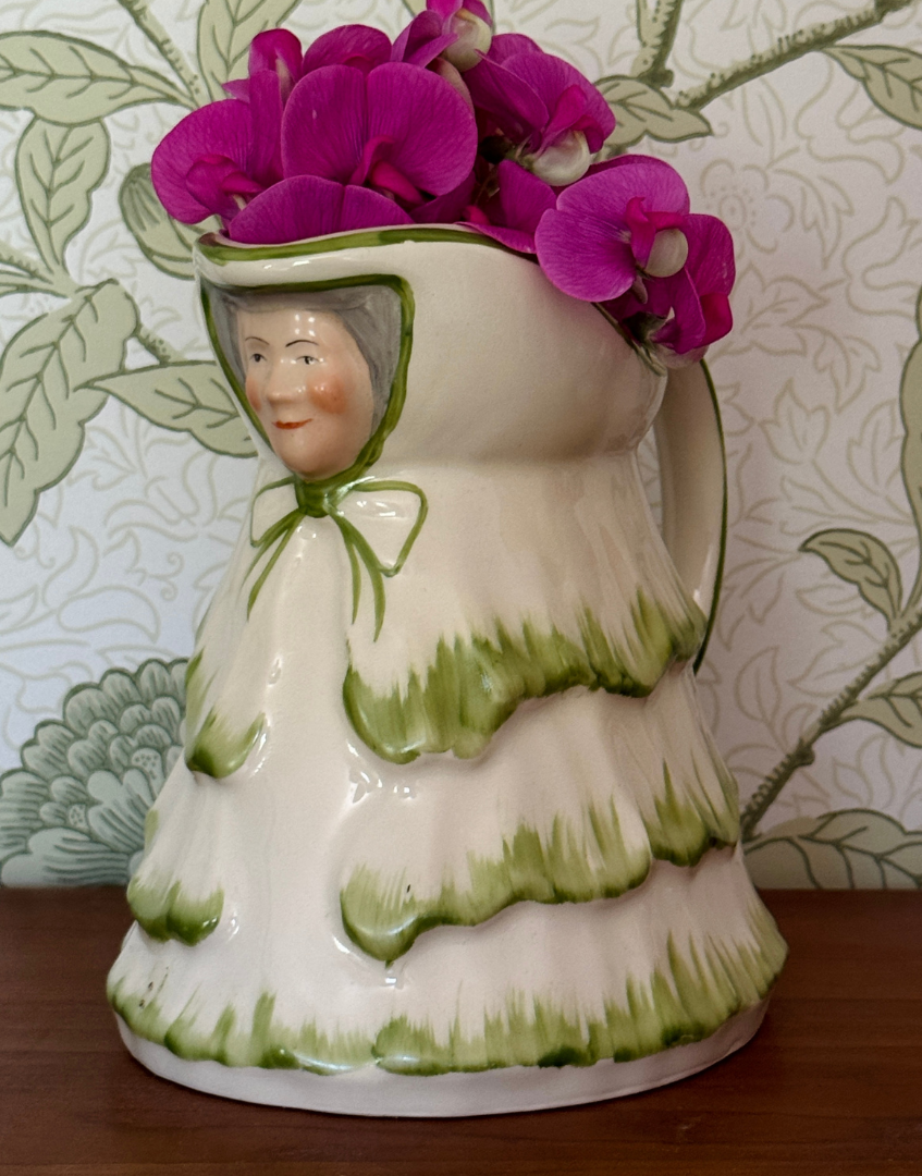 Rare green Tony Wood Little Old Lady  jug styled on wooden shelf with sweet pea flowers