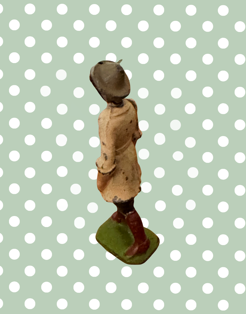 Side view of Britains 1920s Land Girl figure showing green painted base and hand-painted detailing
