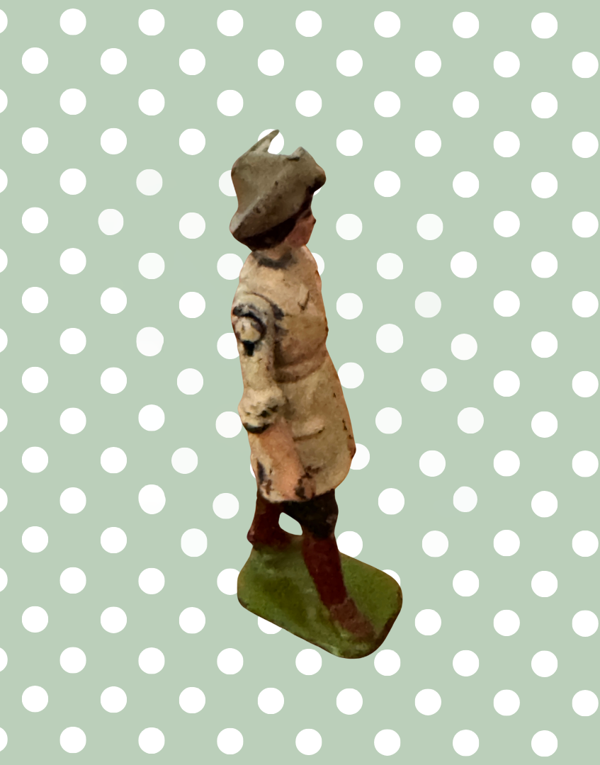 Side view of Britains Land Girl vintage lead figure showing traditional working clothing and articulated arm