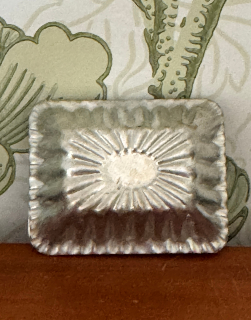 Reverse view of vintage aluminium chocolate mould showing original metal construction and aged finish