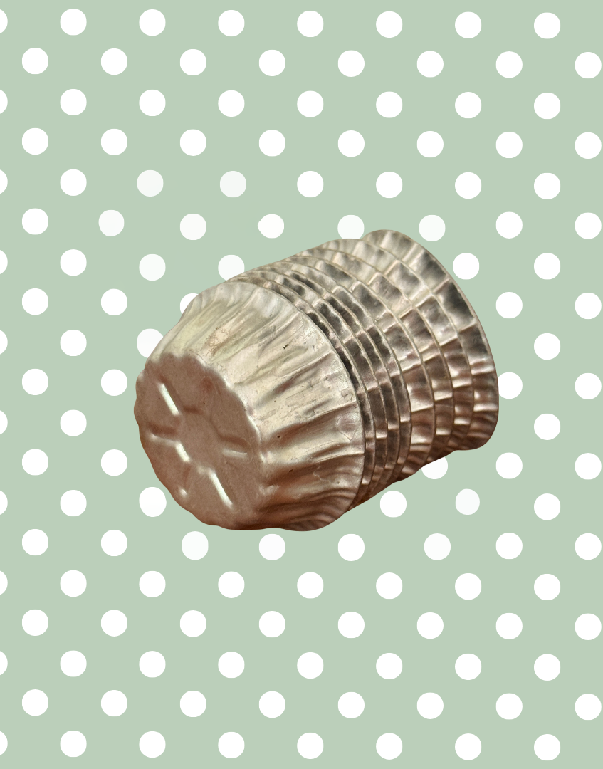 Side view of stacked vintage aluminium star moulds showing embossed star pattern on the base and original culinary design