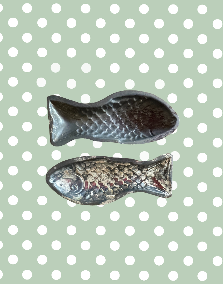 Top view of the remaining two vintage fish shaped aluminium moulds showing detailed form and silver toned finish