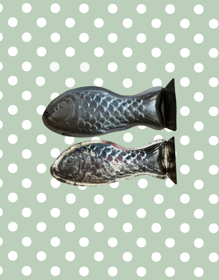 Underside view of two vintage aluminium fish moulds showing construction details and original culinary design