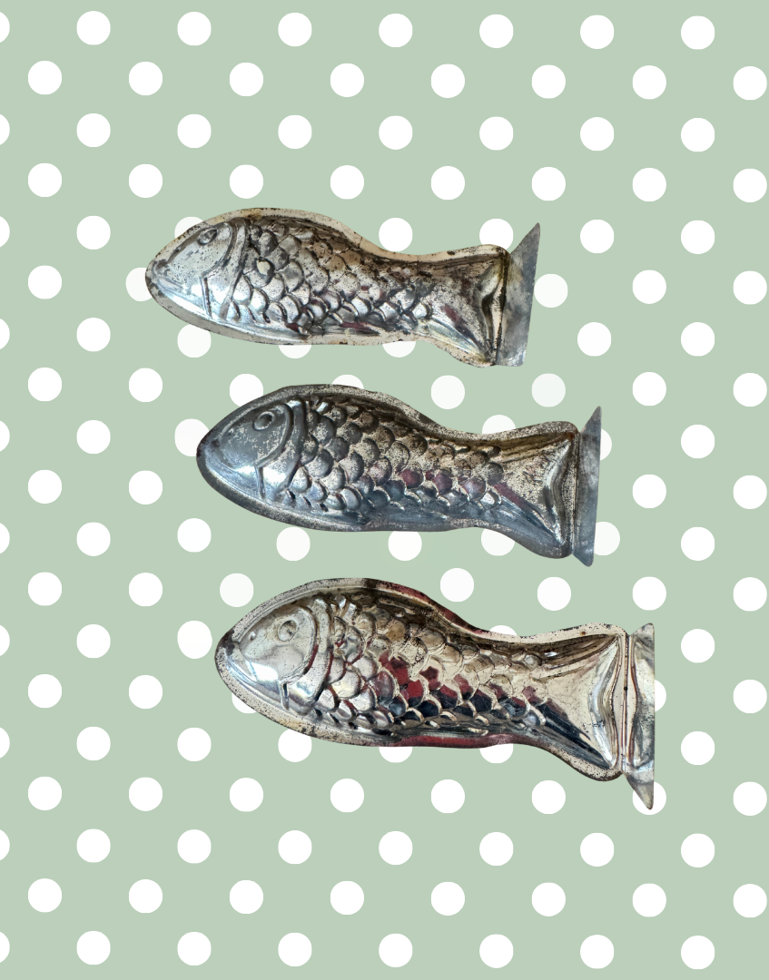 Row of three vintage aluminium fish moulds highlighting the original shape and rustic brocante character