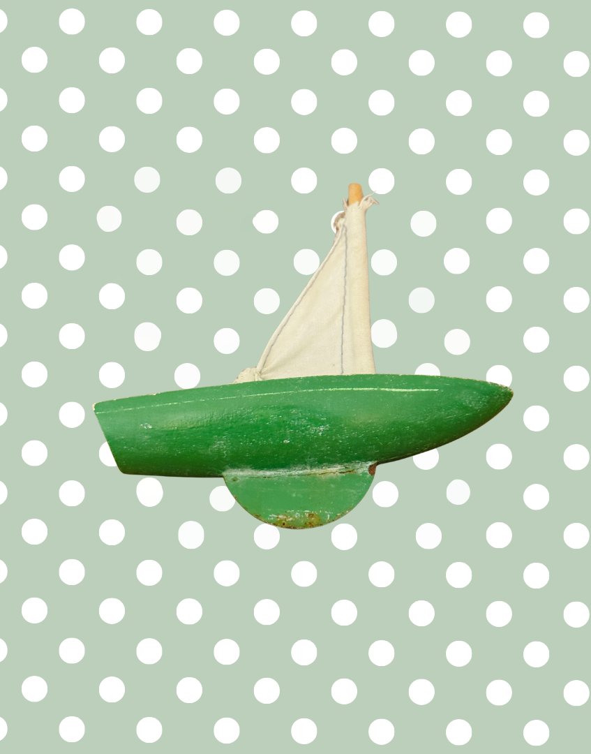 Underside side view of the vintage Star Yachts pond yacht showing the painted wooden hull and aged green keel.
