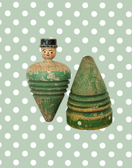Pair of antique early 20th century wooden spinning tops, including a hand carved gentleman and a painted polka dot top.