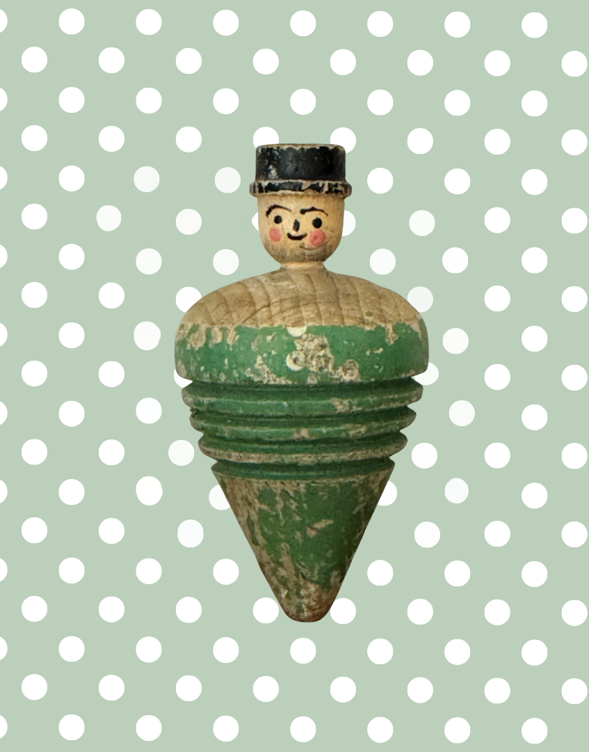 Antique wooden spinning top featuring a hand carved and painted gentleman wearing a bowler hat, dating from approximately 1910 to 1920.