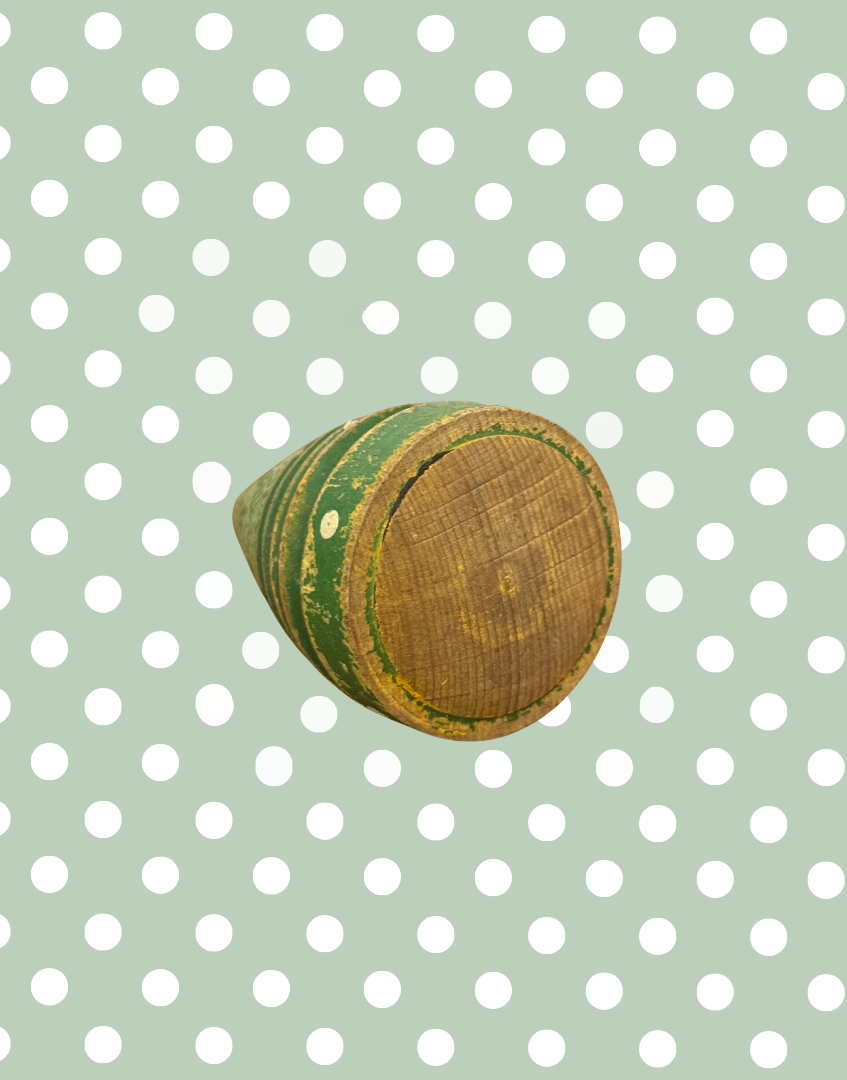 Base of antique wooden spinning top showing the aged wood and original construction details