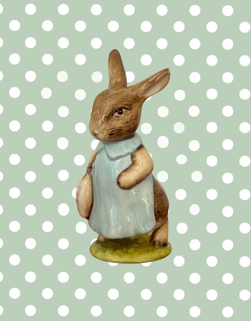 Vintage Beswick Mrs Flopsy Bunny Beatrix Potter figurine in blue clothing on a green base.