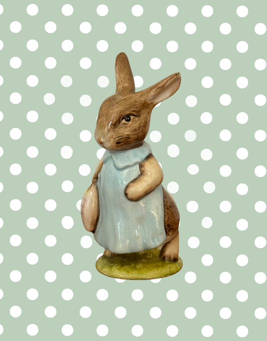Vintage Beswick Mrs Flopsy Bunny Beatrix Potter figurine in blue clothing on a green base.