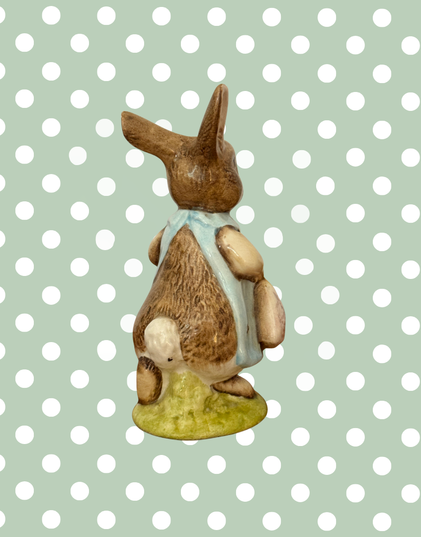 Right rear view of Beswick Mrs Flopsy Bunny showing her white tail and blue clothing.