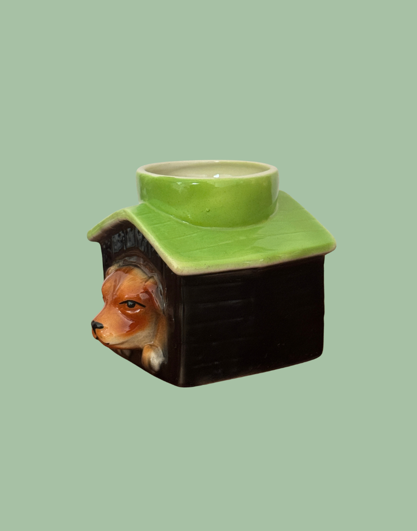 Angled view of Tony Wood dog in kennel egg cup showing the dog’s profile, black kennel side and glossy green roof.
