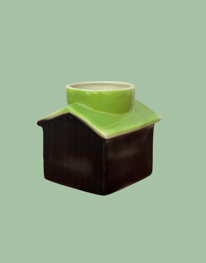 Rear angled view of Tony Wood kennel egg cup showing the subtly ribbed black panels and apple green roof.