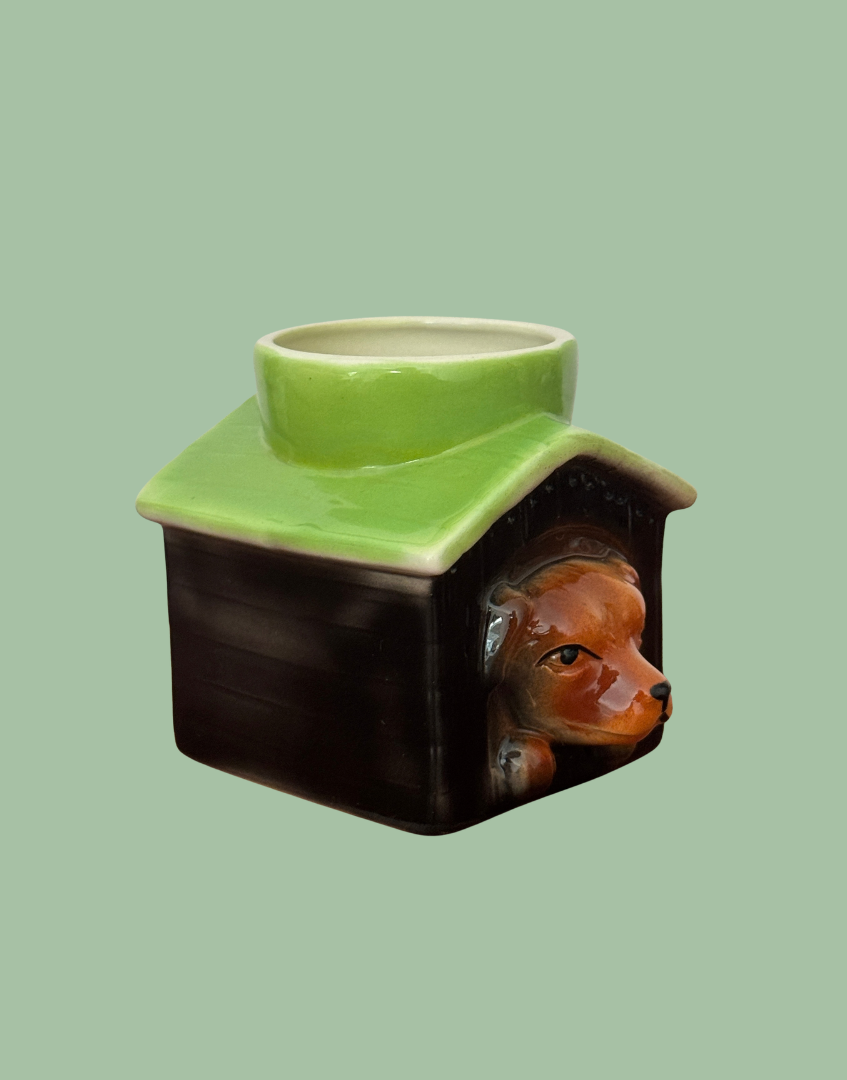 Tony Wood dog in kennel egg cup viewed from the opposite side, showing the projecting dog’s head and boarded kennel detail.