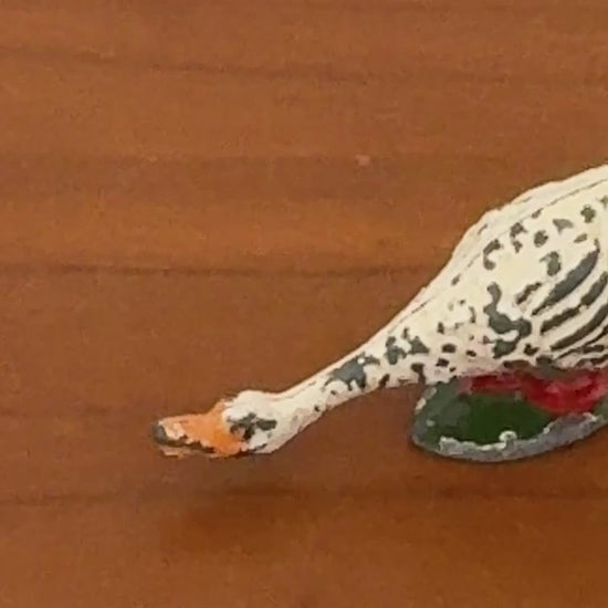 Video of white hand painted hollow cast Britains figurine with orange beak and neck down